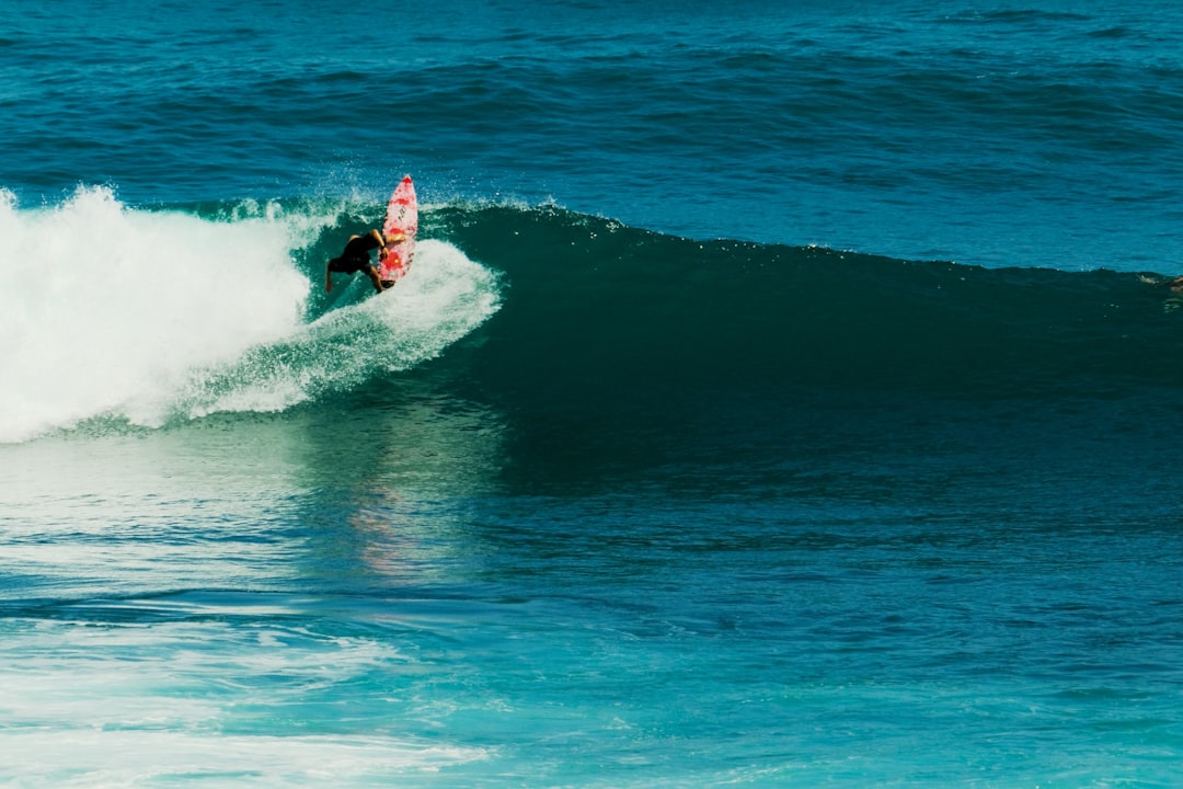 Surfer riding a wave at Uluwatu, Bali - real surf photography by David Gor