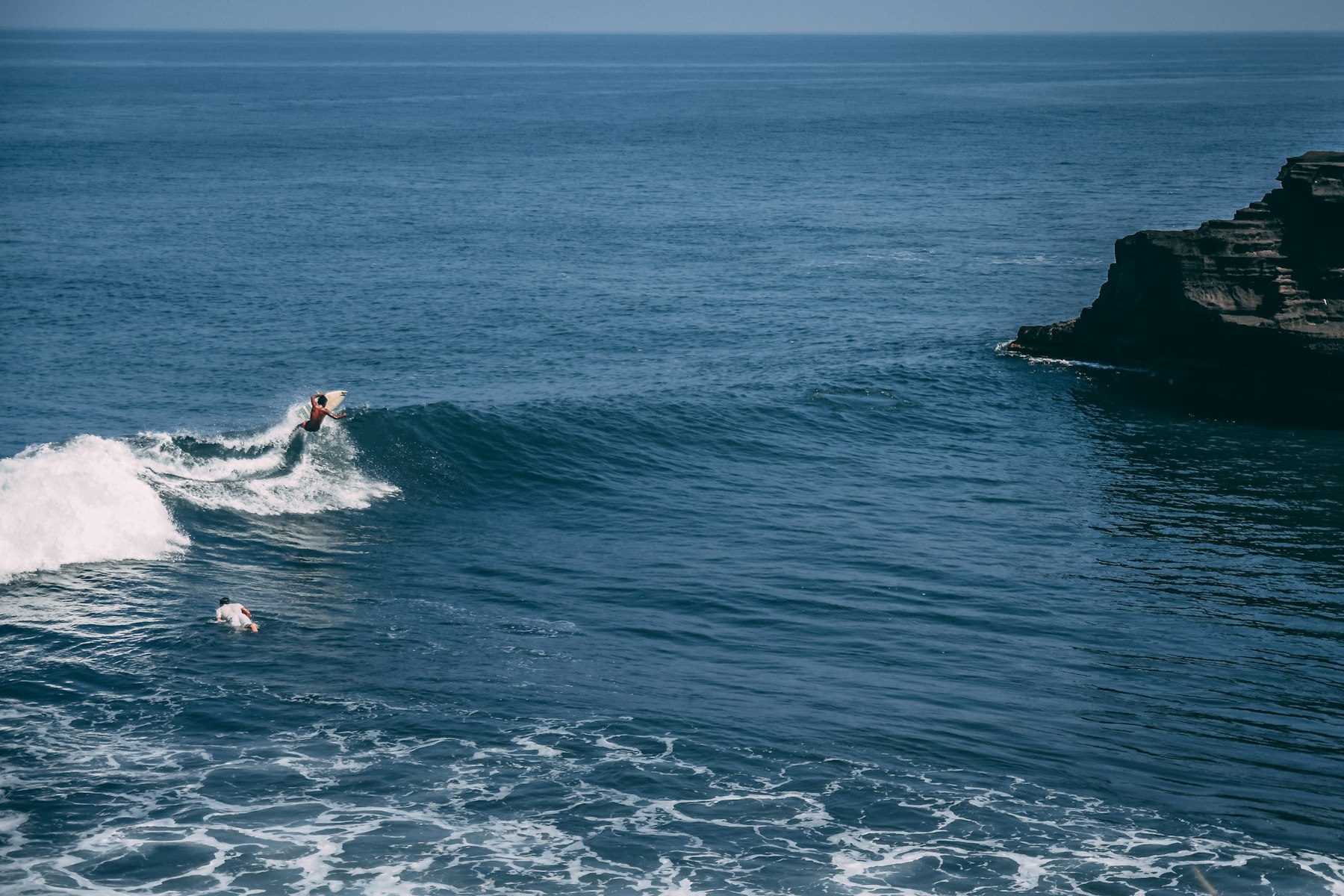 Real surf photography of Uluwatu, Bali - surfer riding a perfect barrel wave